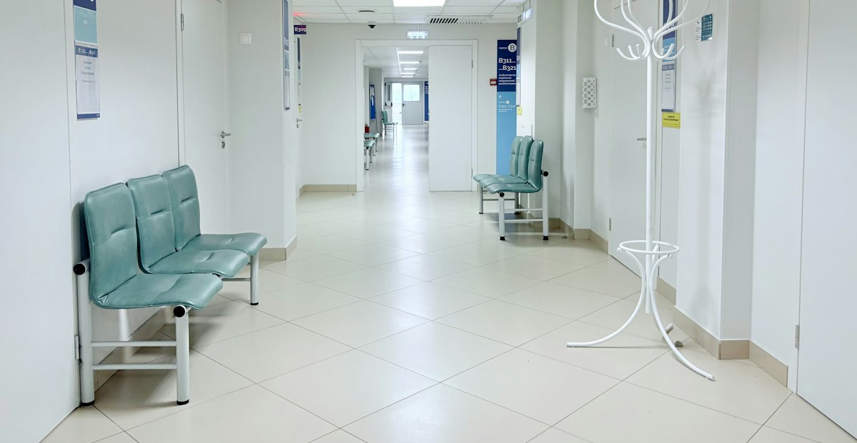 A quiet clinic corridor with benches
